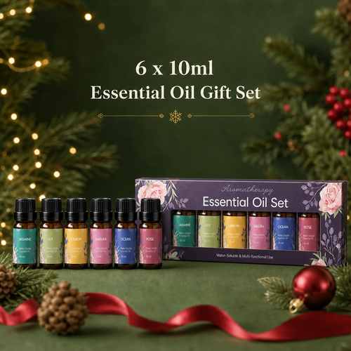 A 6-piece essential oil gift set displayed with six small amber bottles in front of their floral purple packaging box. The set includes various scents like Lavender, Lemon, Peppermint, Rose, Ocean, and Balm.